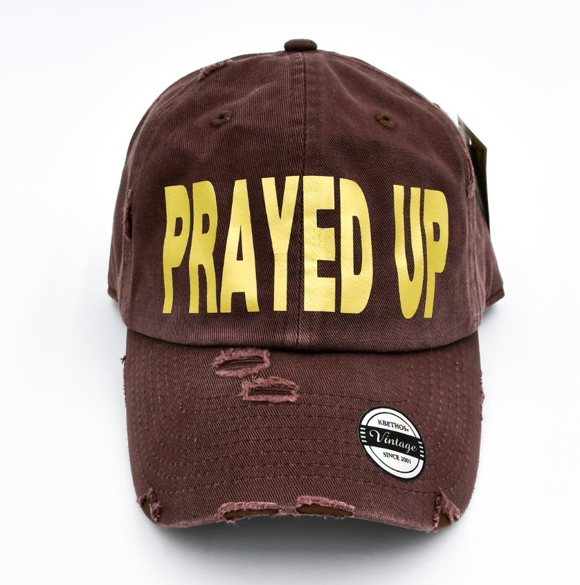 Brown cap with 'PRAYED UP' in yellow on a white background